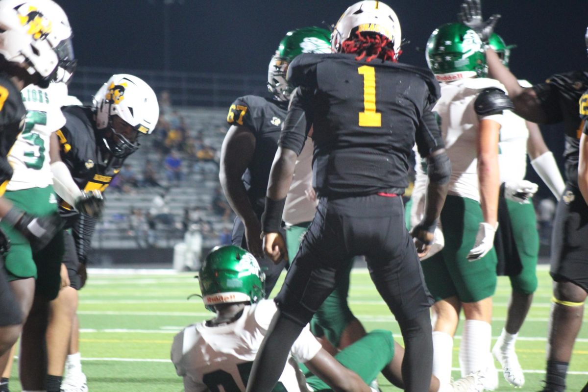 Dragons' Quarterback Tyren Matthews standing over a Livingston player after a big run by Matthews during the homecoming football game on Sept. 13.