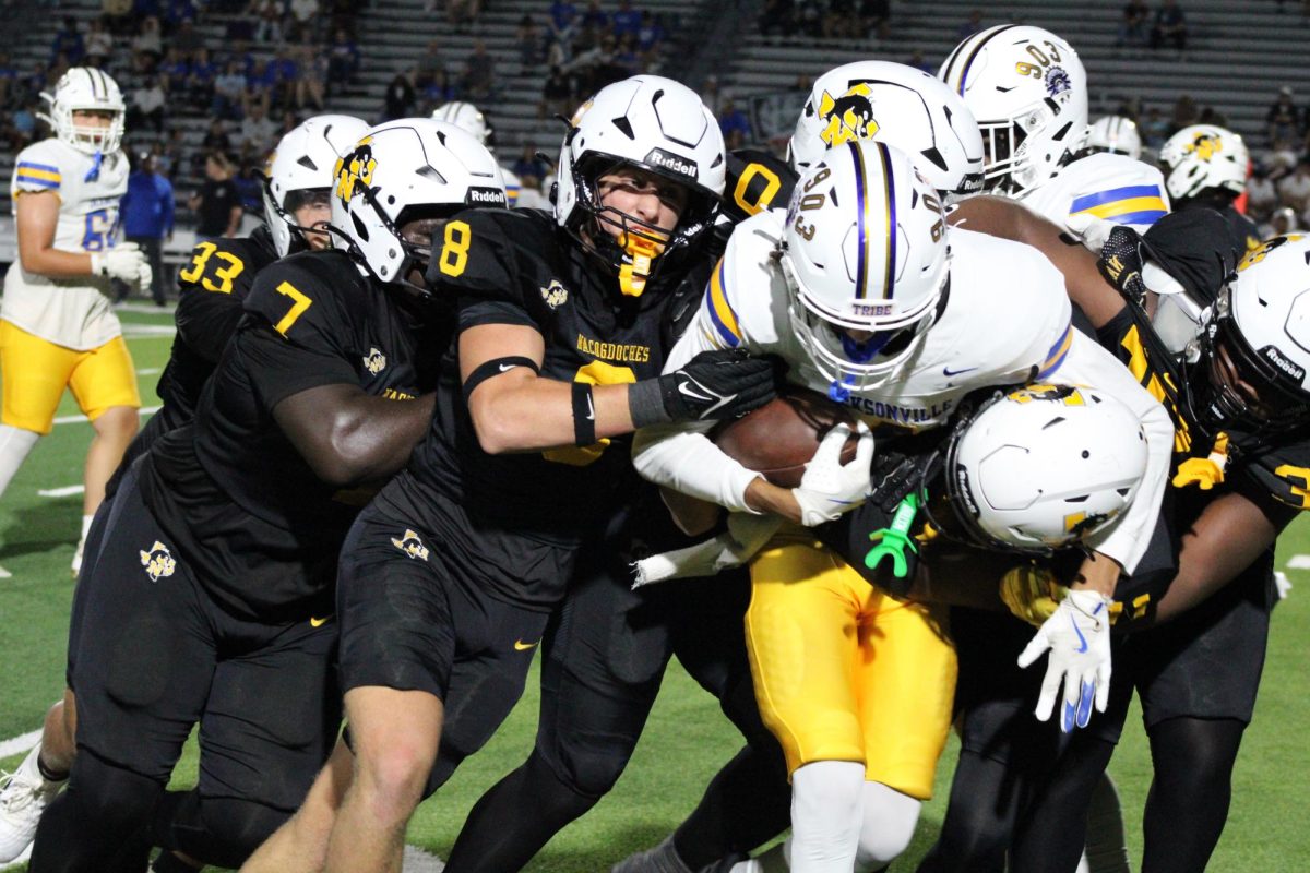 DRAGONS DEFEAT INDIANS - Defensive line holds firm in varsity game against Jacksonville on Friday